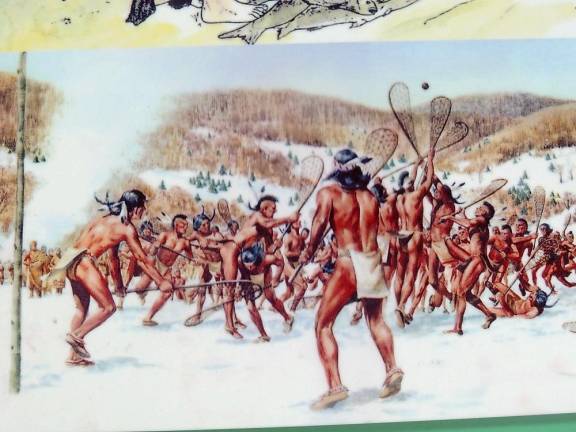 Bright red Indians play lacrosse in the snow (Photo and caption by Rick Patterson)