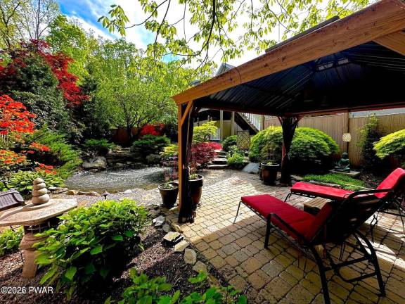 Home on private retreat has pond and waterfalls