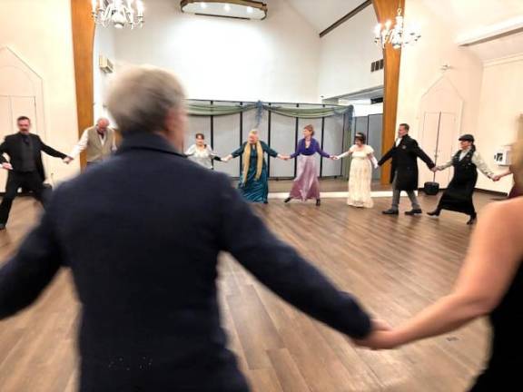 Attendees participate in a Regency-era dance at the Hanna Q Dance Company ball.