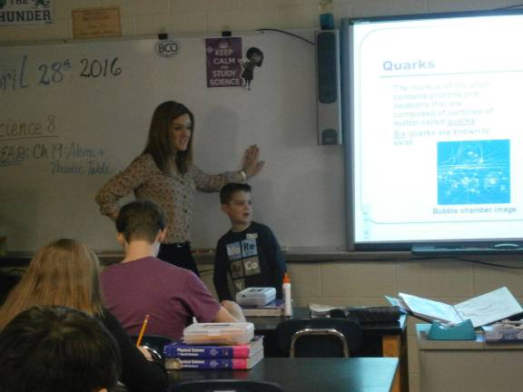 Mrs. Devine helps son Donovan review science notes with the class (Photo provided)