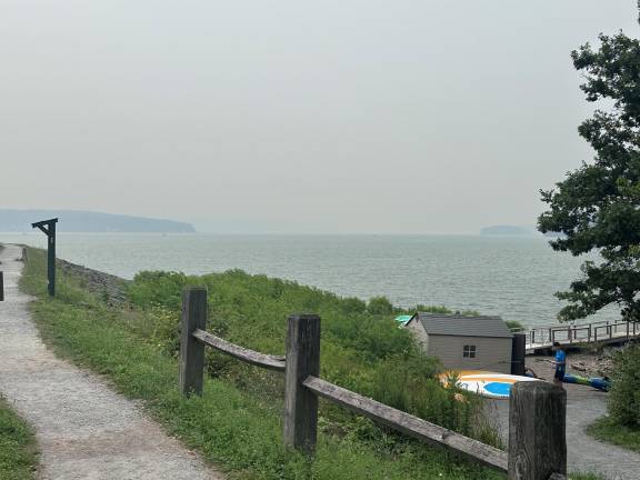 Smoke decends over a lake. Photo taken around 1 p.m. on Thursday, July 16. Photo: Dan Bartley, Greentown.