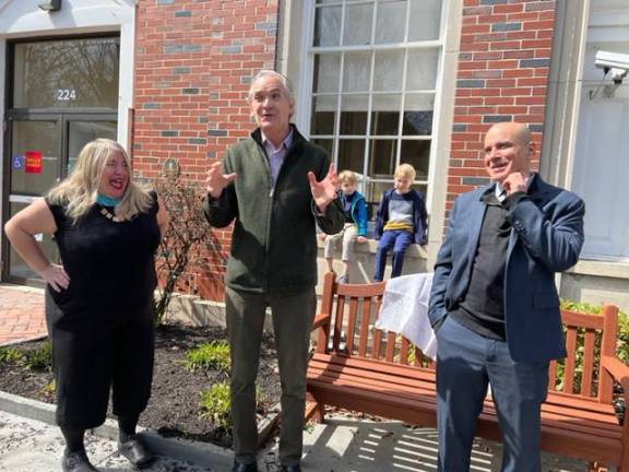 Milford Mayor Sean Strub talks, as she is flanked by Susie and Hugh Siegel on April 2. Quentin and Karl Wagner are sitting on the window sill in back.
