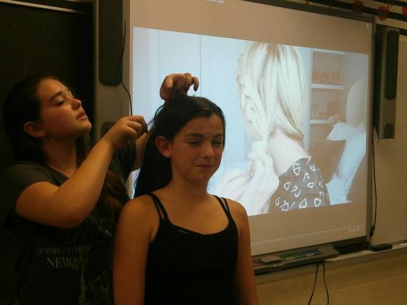 Sophia Perrin styles Bridget Gendreau's hair (Photo provided)