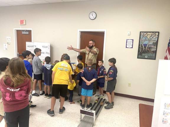 Cubmaster Mike Gillespie addresses children at a 2025 STEM event.