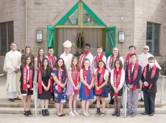 Bishop Bambera is pictured here with the Confirmation candidates just before the celebration of the Eucharistic Liturgy and Confirmation ceremony. Looking on are Father Joseph Manarchuck, Pastor, and Deacon Thomas Spataro (Photo by Jay A. Asper)