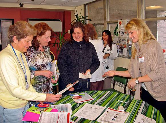 Bon Secours business office staff, from left, Gail Williamson, Linda Ridella and Colleen Rispoli collect information about an upcoming &quot;Heart Walk&quot; from Amy Hardisty, special events manager for the American Heart Association.