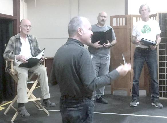 Director Jeffrey Stocker and cast members at rehearsal.