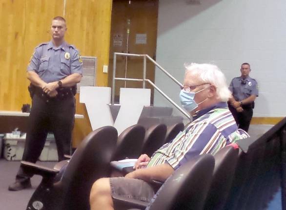 Two police officers stood sentinel over the fractious meeting (Photo by Frances Ruth Harris)