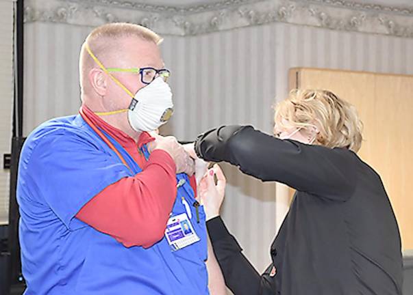 Dr. Stanley Skonieczki, medical director of the Wayne Memorial Hospital Emergency Department is vaccinated by Kristy Tirney, RN, against Covid-19 (Photo provided)