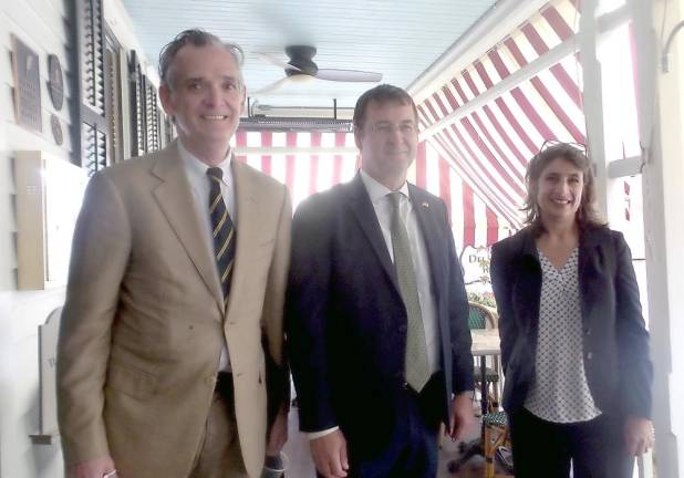 From left: Milford Mayor Sean Strub, German Consul General David Gill and his wife, Shelia, on the porch of the Hotel Fauchère on Tuesday (Photo by Frances Ruth Harris)