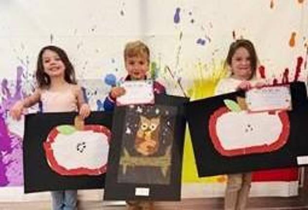 Logan Kent, Riley Boyle, and Paityn Bult with their art work.