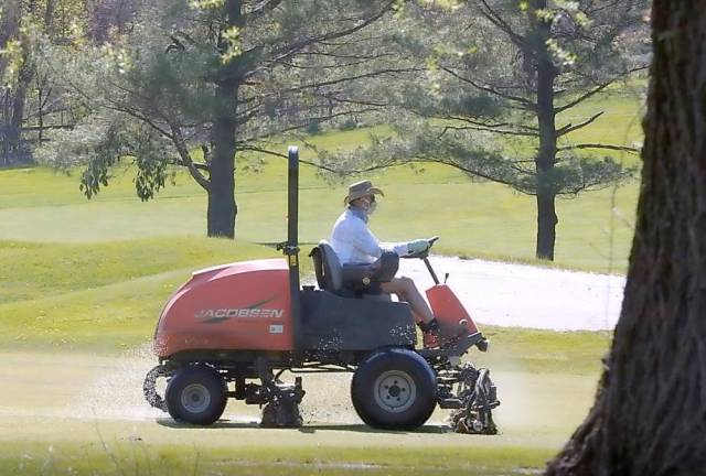A groundskeeper keeps the grass trim at Great Gorge Golf Course in Vernon.