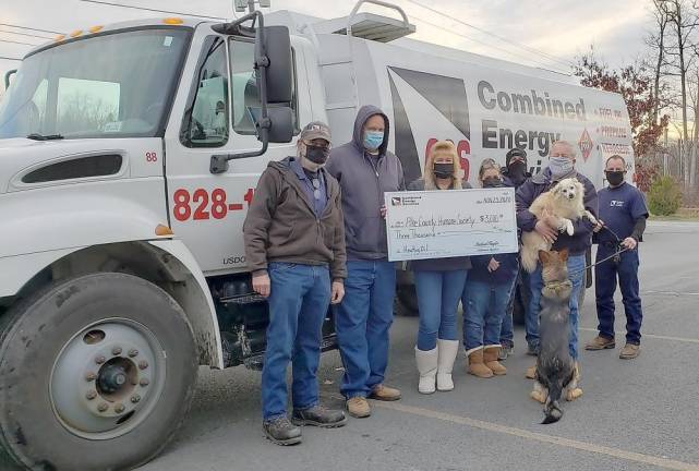 The symbolic check for $3,000 was presented to Barry Heim, executive director of the Pike County Humane Society, by the CES Dingmans crew – Dan, Jim, Marla, Tracy, Ed, and Chris. The camera-shy German shepherd is available for adoption! (Photo provided)