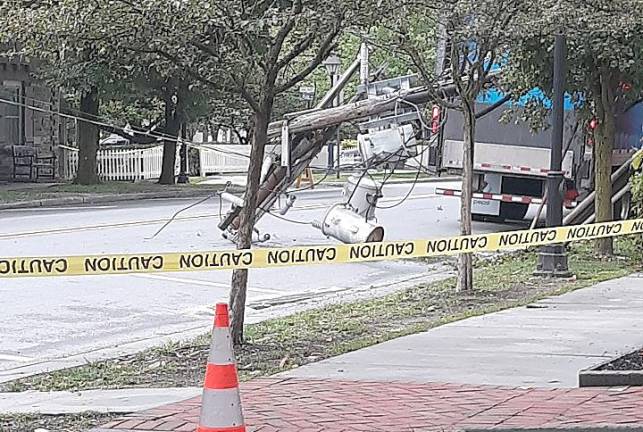 Three transformers hung from wires in front of Wells Fargo Bank on Broad St. after a Pepsi tractor-trailer collided with a utility pole.