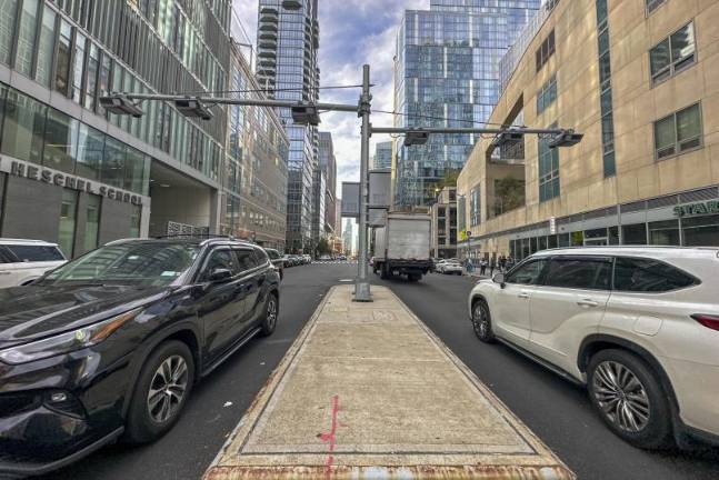 Recently installed toll traffic cameras hang above West End Ave. near 61st Street in the Manhattan borough of New York, Friday, Nov. 16, 2023. The start date for the $15 toll most drivers will be charged to enter Manhattan's central business district will be June 30, transit officials said Friday, April 26, 2024. (AP Photo/Ted Shaffrey, File)
