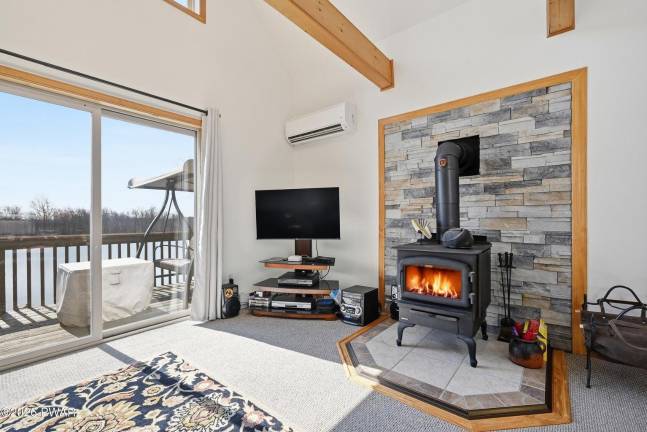 Tri-level modern lakefront comes with panoramic views and dock