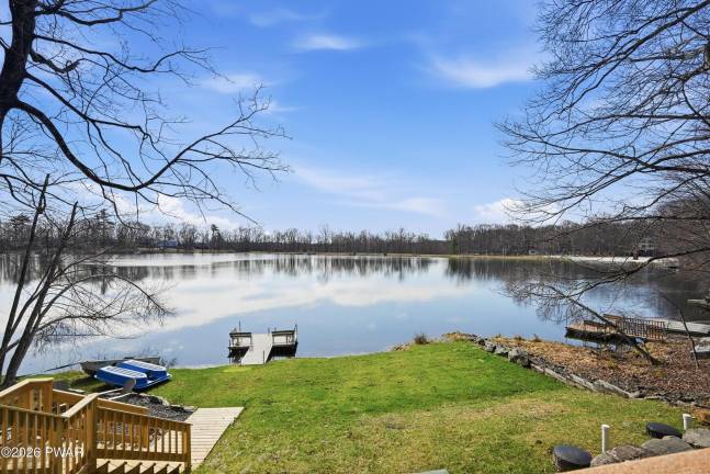 Tri-level modern lakefront comes with panoramic views and dock
