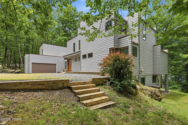 Upscale modern lakefront has private dock, media room and home gym