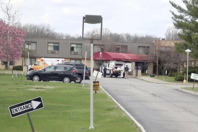 Ambulance crews are parked outside Andover Subacute and Rehabilitation Center in Andover, N.J., on April 16, 2020. Police responding to an anonymous tip found more than a dozen bodies at the nursing home (AP Photo/Ted Shaffrey)