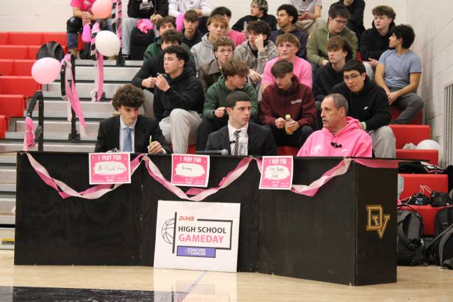 DVHS journalists Lucas Petersheim and Mike Iuzzolino with and boys basketball assistant coach and cancer survivor Al Holtzer.