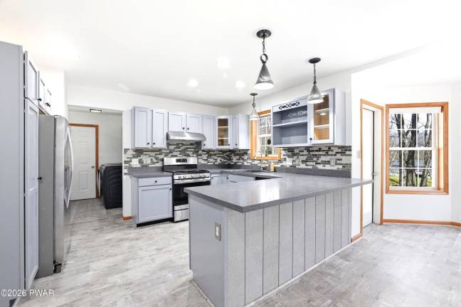 Modern four-bedroom home is move-in ready on a treed acre