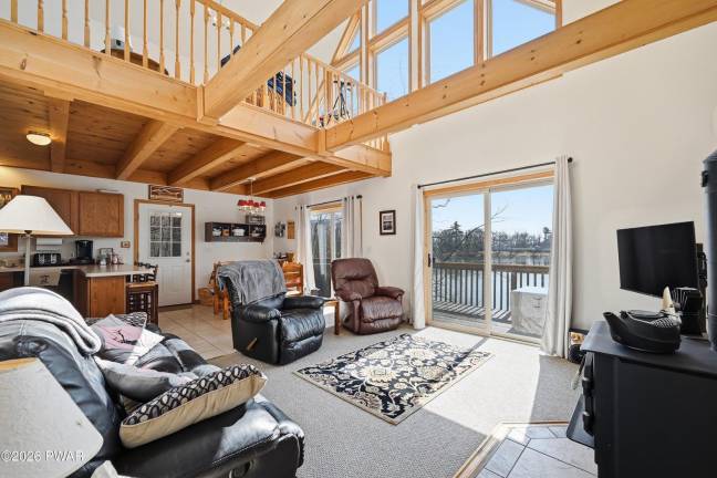 Tri-level modern lakefront comes with panoramic views and dock