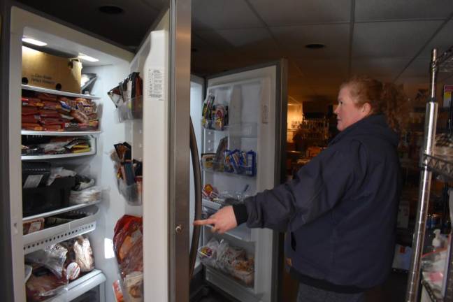 Harvest House kitchen manager Kelly Immesberger shows two of three freezers full of meat. Food donations come from ShopRite Weiss, Holland America Bakery, Acme, the Sparta food pantry and community members.
