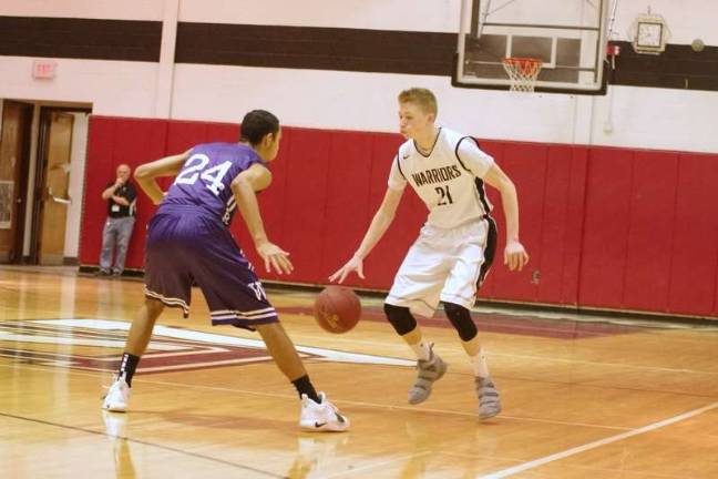 Delaware Valley's Blake Gearhart dribbles the ball while covered by Wallenpaupack's Izaiah Santiago. Gearhart scored 16 points (Photo by George Leroy Hunter)