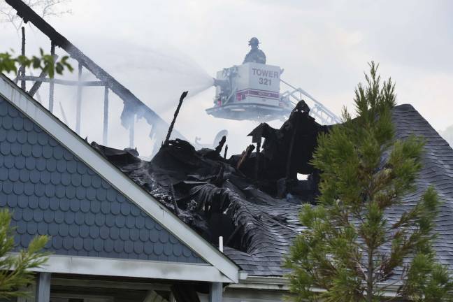 Firefighters from Orange, Pike, and Sussex counties extinguish a blaze that heavily damaged several townhouse units in Matamoras (Photo by Robert Breese)
