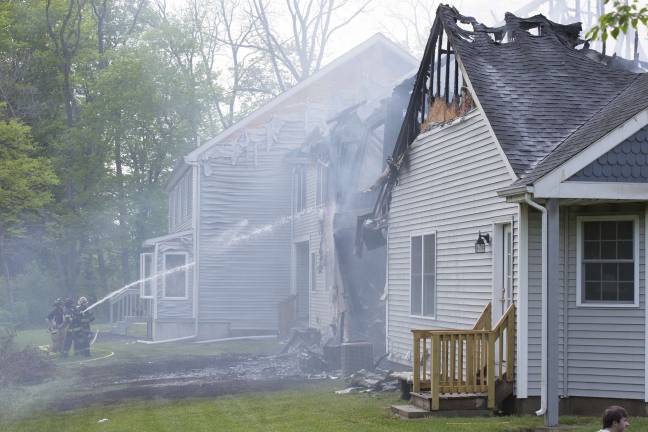 Firefighters from Orange, Pike, and Sussex counties extinguish a blaze that heavily damaged several townhouse units in Matamoras (Photo by Robert Breese)