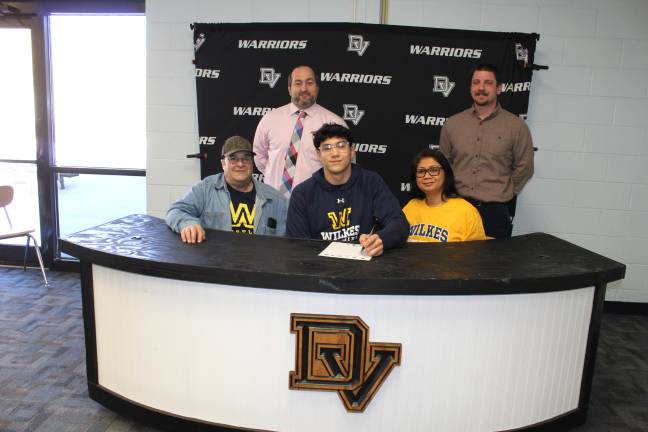 JJ Segal signs his letter of intent to continue wrestling at Wilkes University. Front row (L-R): Steve Segal, JJ Segal, and Esfe Segal. Back row (L-R): Head coach Lou DeLauro and assistant coach Nick Irwin.