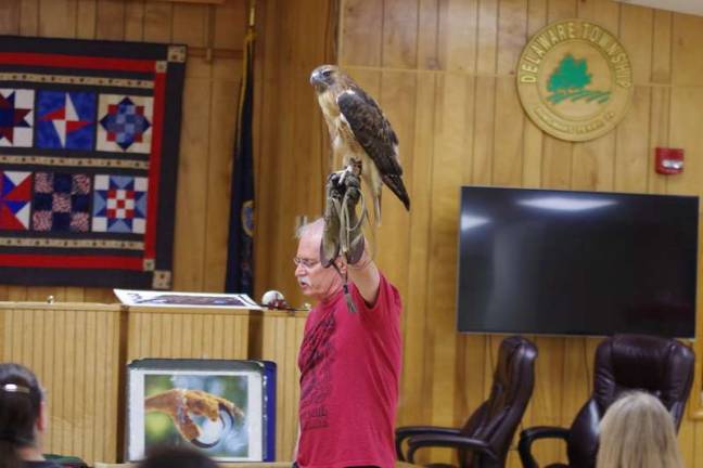 Neekahna, a red tailed hawk, sat perched on William Streeter's hand as he spoke. (Photo by George Leroy Hunter)