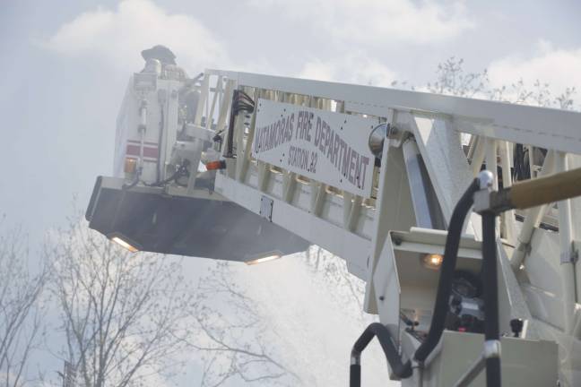 A Matamoris tower ladder operates at the townhouse fire (Photo by Robert Breese)