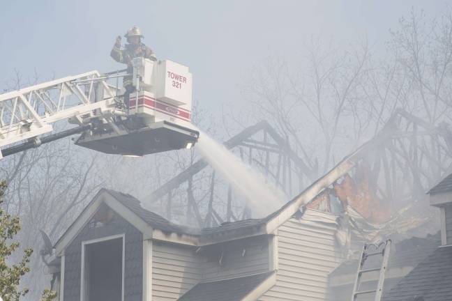 Firefighters from Orange, Pike, and Sussex counties extinguish a blaze that heavily damaged several townhouse units in Matamoras (Photo by Robert Breese)