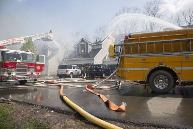 Firefighters from Orange, Pike, and Sussex counties extinguish a blaze that heavily damaged several townhouse units in Matamoras (Photo by Robert Breese)