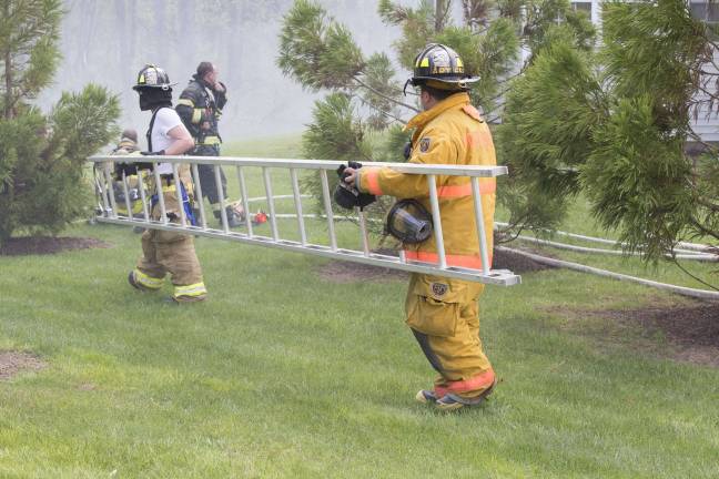 Firefighters from Orange, Pike, and Sussex counties extinguish a blaze that heavily damaged several townhouse units in Matamoras (Photo by Robert Breese)