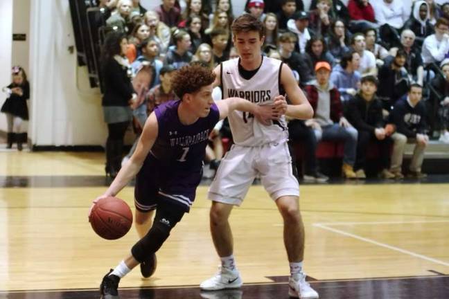 Wallenpaupack's Elijah Rosenthal dribbles the ball past Delaware Valley's Grant Berrios. Rosenthal scored 29 points (Photo by George Leroy Hunter)