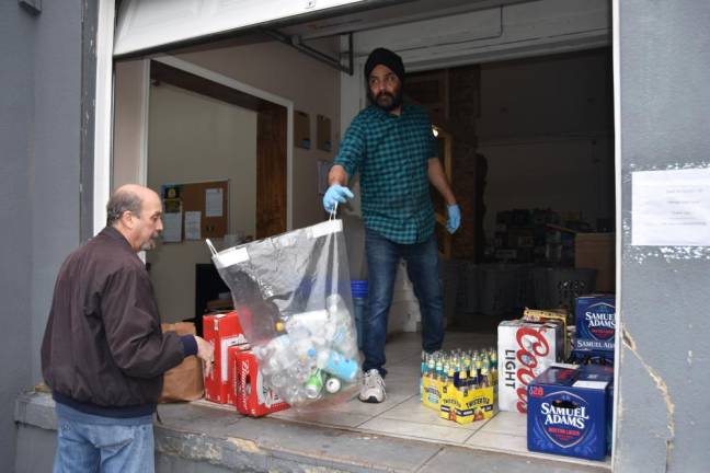 Tony Aneja opened the roll-up door at the loading dock, so his Cash for Cans customers can line up outside.