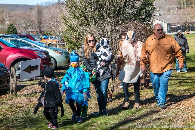 A family marches in the parade.