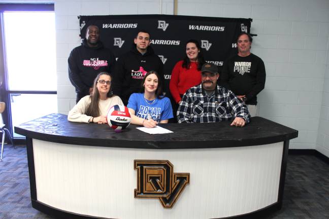 Samantha Prisco signs her letter of intent to play volleyball at Penn College of Technology. Front row (L-R): Amy Prisco, Samantha Prisco, and Sal Prisco. Back row (L-R): Club coach Shawn, club coach Davian, head coach Karley May, and coach Adam Holdredge.