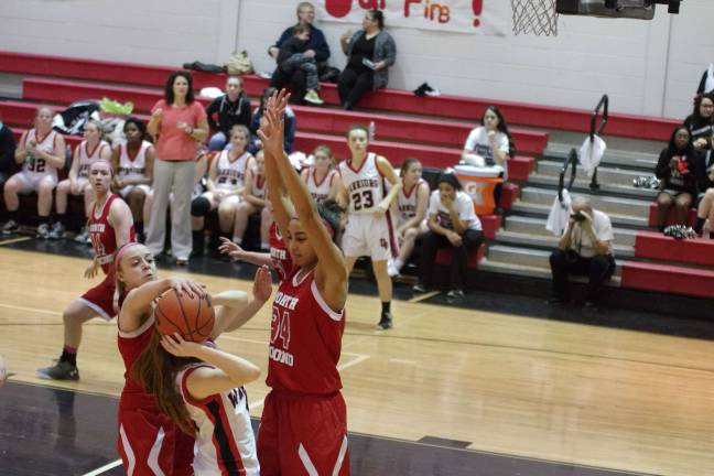 The North Pocono defense denies a Delaware Valley shooter access to the hoop.