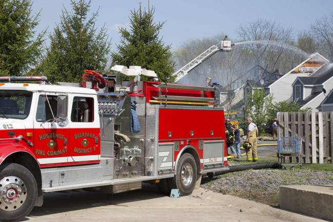 Firefighters from Orange, Pike, and Sussex counites extinguish a blaze that heavily damaged several townhouse units on Grey Cliff Court (Photo by Robert Breese)