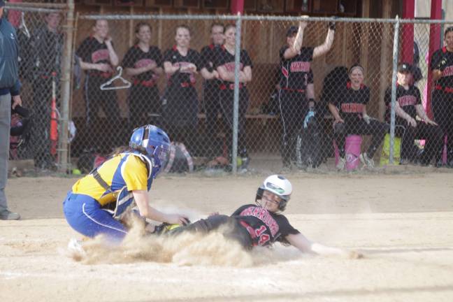 Delaware Valley Warrior McKenna Quinn slides into home plate. Quinn was ruled out.
