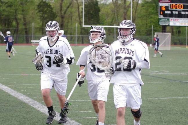Delaware Valley Warriors Brandon Haraldsen, Ryan Obiso and Neil Roche jog off the field during a break.