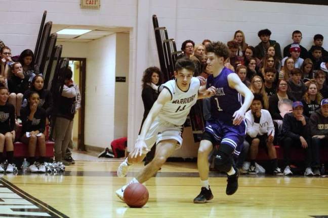 Delaware Valley's Grant Berrios dribbles the ball past Wallenpaupack's Elijah Rosenthal. Berrios scored 8 points (Photo by George Leroy Hunter)