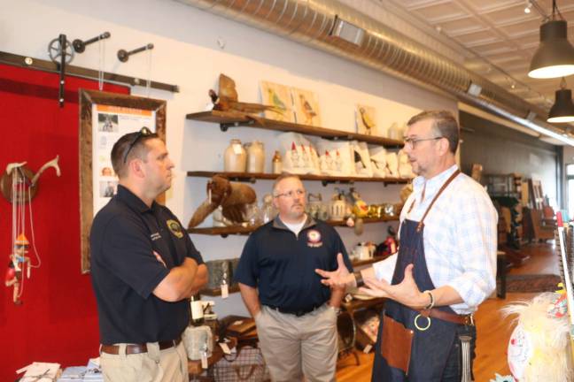 County Executive Neuhaus (left) and Legislator Tom Faggione (center) speak with Cooper Boone (right), owner of Foundry42 (Photo provided)