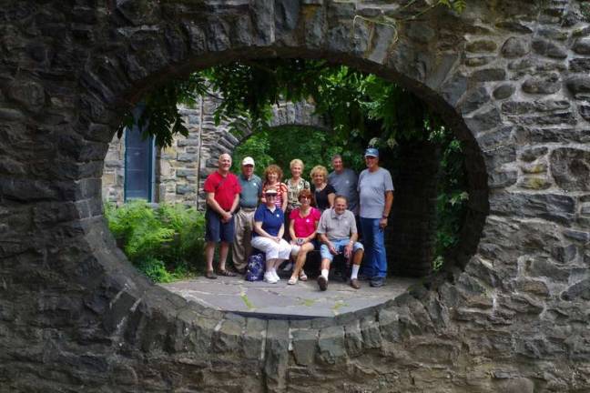 Jeanette Peluso (at far left seated) of Lake Ariel with friends in a portrait framed by a hollowed section of a stone wall at the entrance to 'The Bait Box'. The Bait Box is an elaborate play house built for the son of former Pennsylvania Governor Gifford Pinchot.