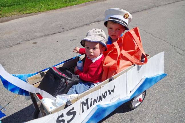 One-year-old Wyatt DeLeeuw of Greeley and three-year-old Jack Rechtoro of Nashville, N/C., portray Gilligan and the Skipper of the &quot;Gilligan's Island&quot; television show. Their wagon depicts the ill-fated SS Minnow. (Photo by George Leroy Hunter)