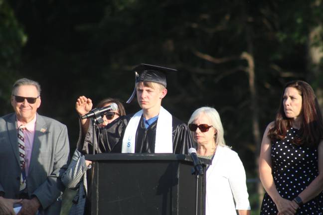 Senior Jaxson Hazard leading the crowd in the Pledge of Allegiance.