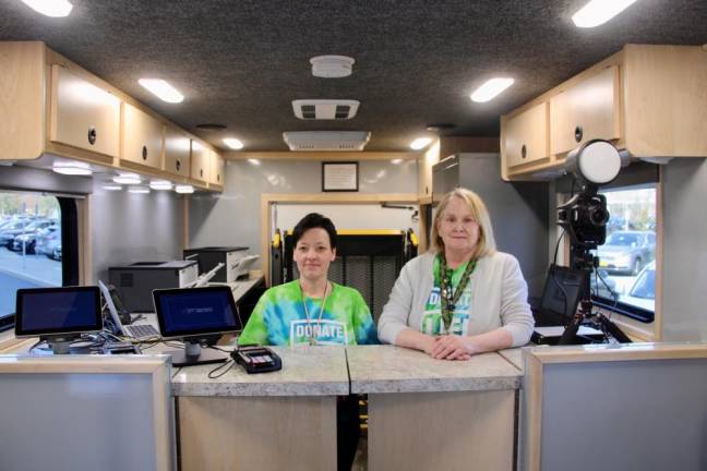 Director of Goshen DMV Lisa Greaves and Deputy County Clerk-DMV Patricia McMullen inside the new Mobile DMV Unit.